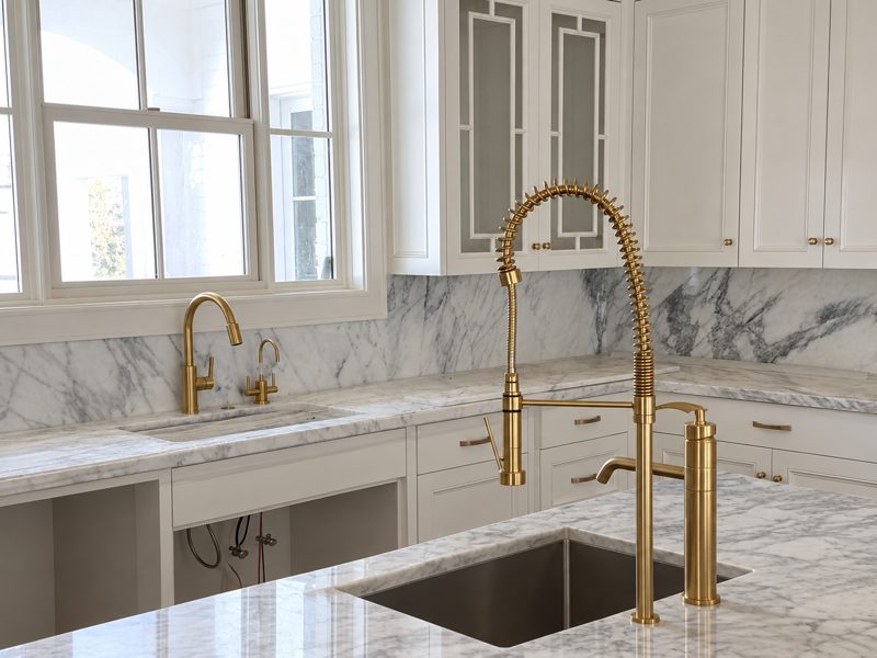 Kitchen counter with brass faucet over an undermount sink